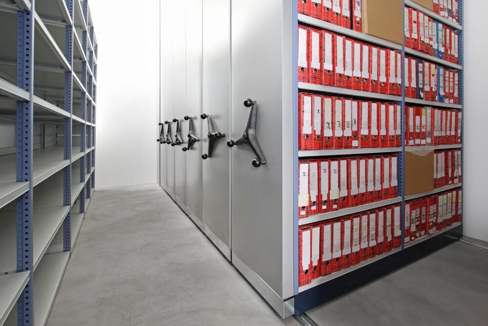 A row of steel cabinets filled with file folders.